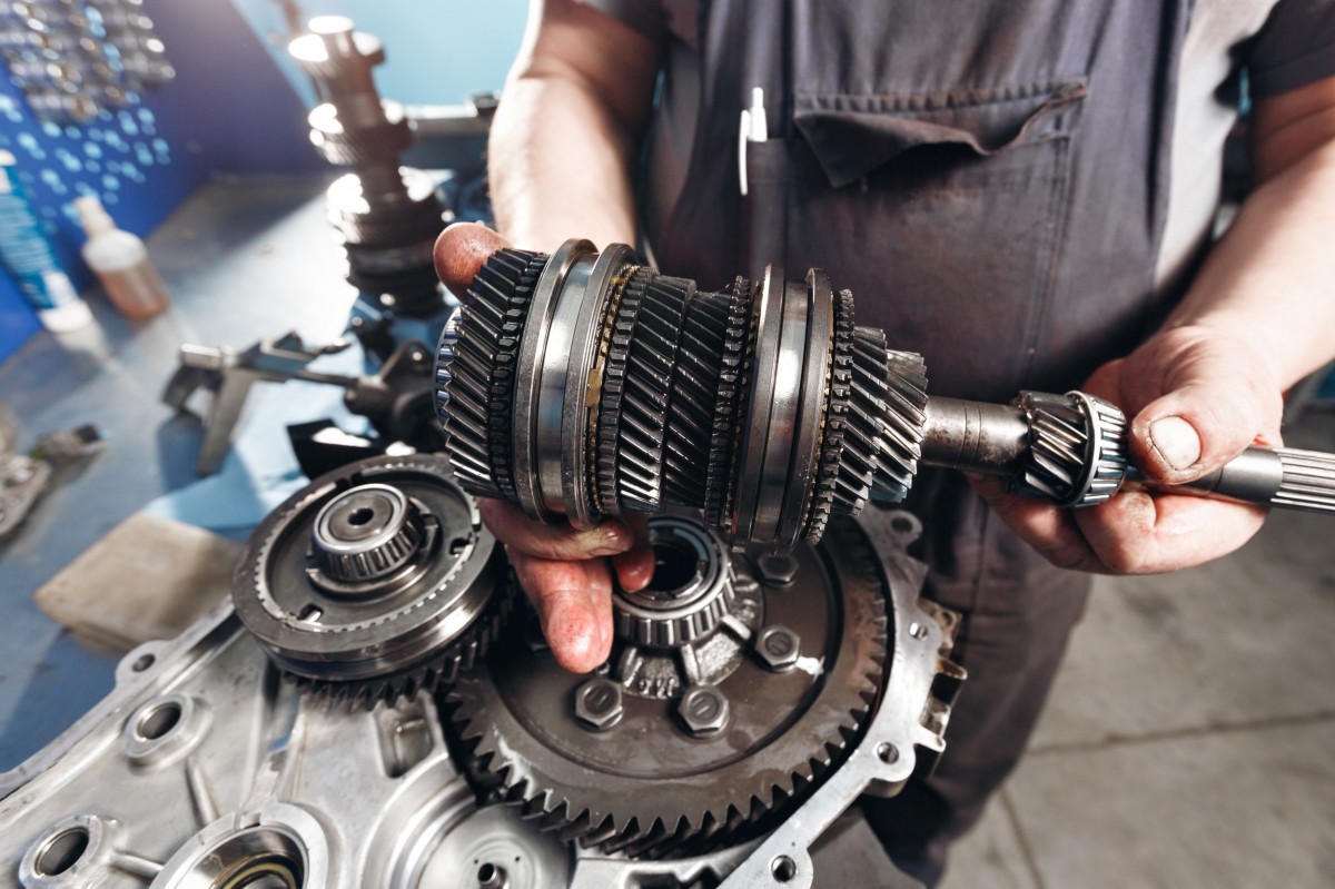 mechanic holding a transmission