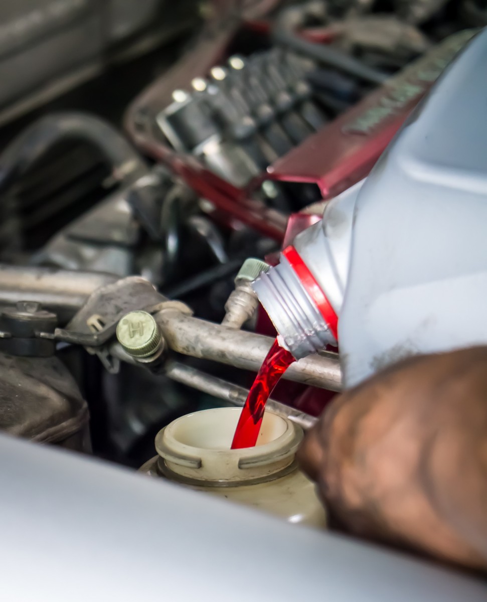 transmission fluid being poured into car